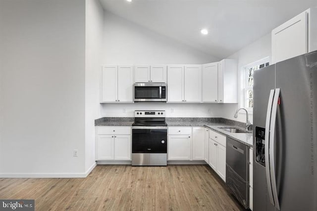 kitchen with sink, light hardwood / wood-style flooring, white cabinetry, stainless steel appliances, and high vaulted ceiling