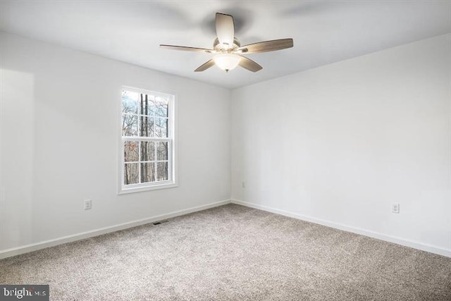 empty room featuring ceiling fan and carpet flooring