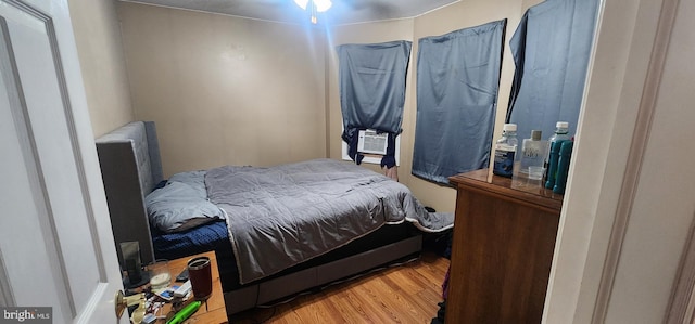 bedroom featuring cooling unit and light hardwood / wood-style flooring