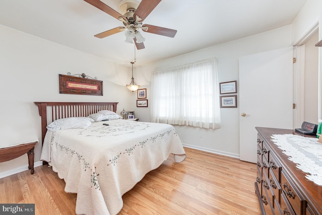 bedroom with hardwood / wood-style flooring and ceiling fan