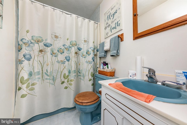 bathroom with vanity, tile patterned flooring, and toilet