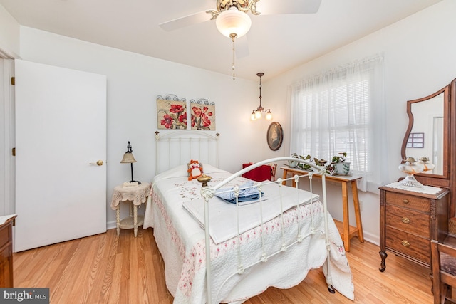 bedroom with ceiling fan and light hardwood / wood-style floors