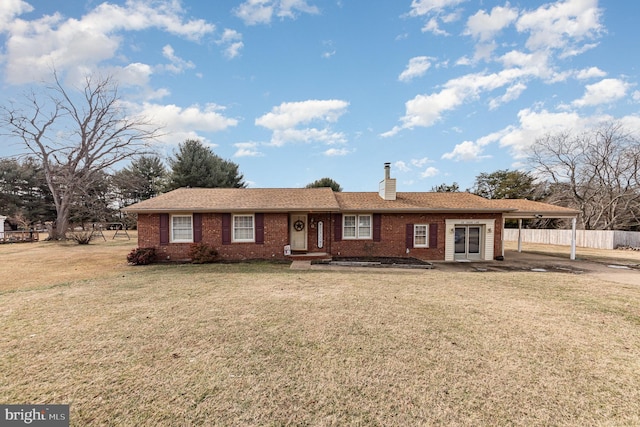 single story home with a front lawn and a carport