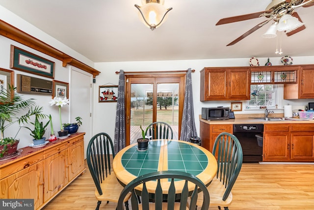 dining room with ceiling fan, light hardwood / wood-style floors, and sink