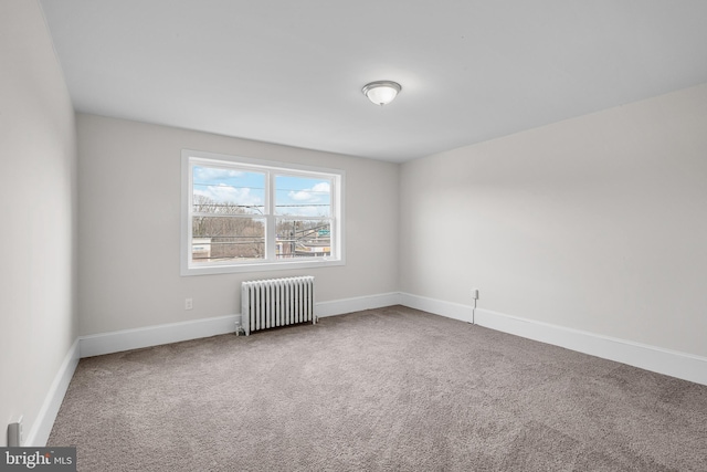 unfurnished room with carpet and radiator