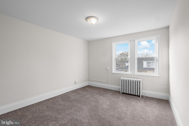 empty room with radiator heating unit and carpet