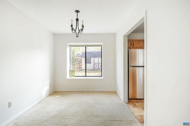 unfurnished dining area with light carpet and a notable chandelier