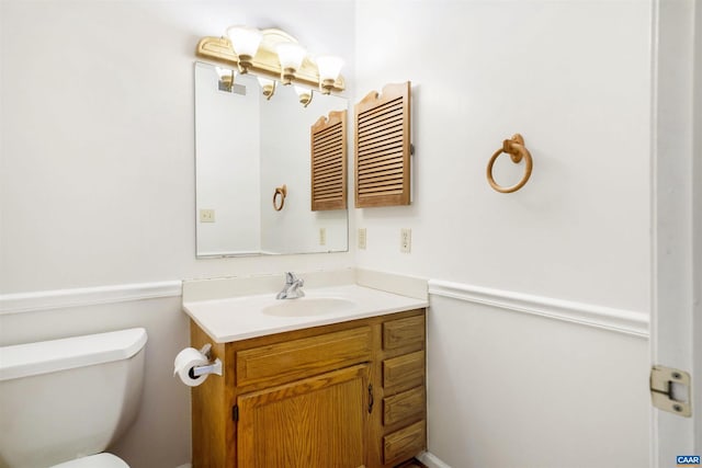 bathroom featuring vanity and toilet