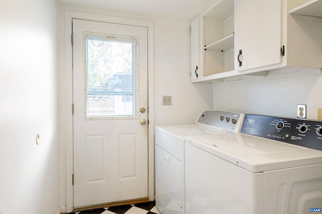 laundry room featuring separate washer and dryer and cabinets