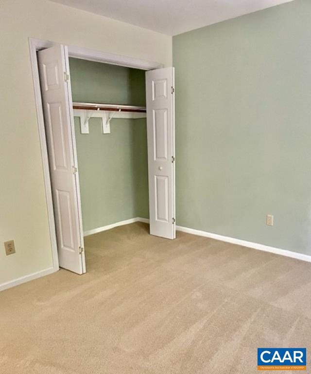 unfurnished bedroom with carpet floors and a closet