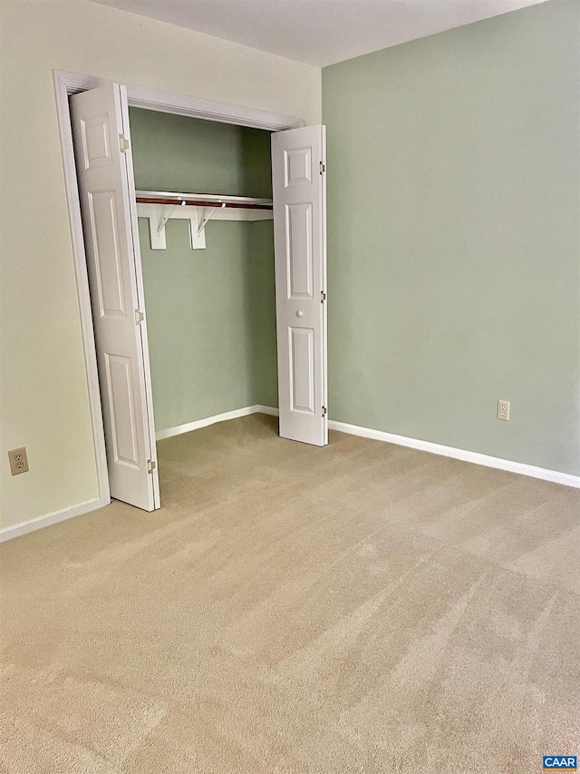 unfurnished bedroom featuring a closet and carpet