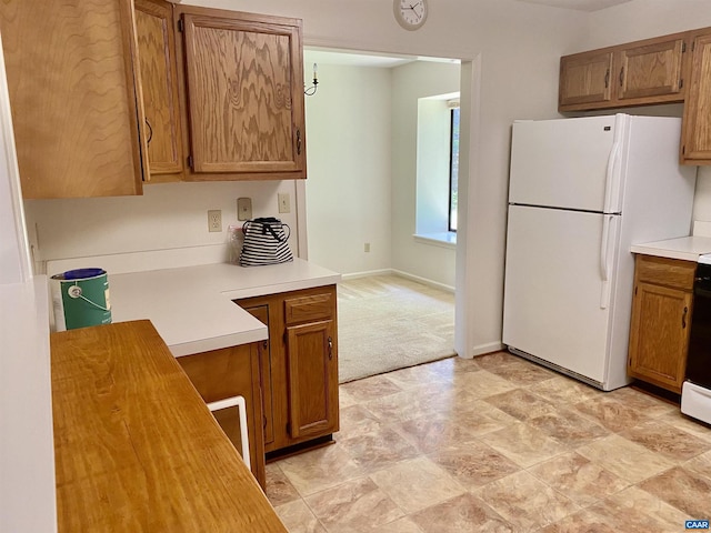 kitchen with light colored carpet and white fridge