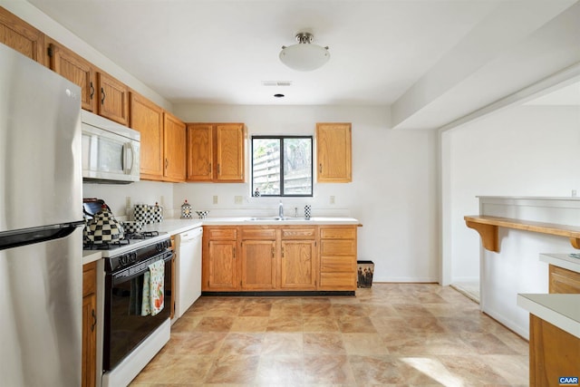 kitchen featuring sink and white appliances