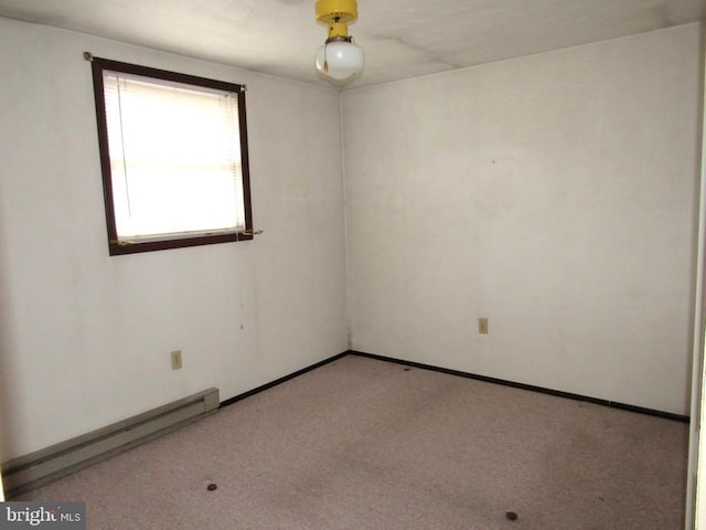 carpeted empty room with baseboard heating