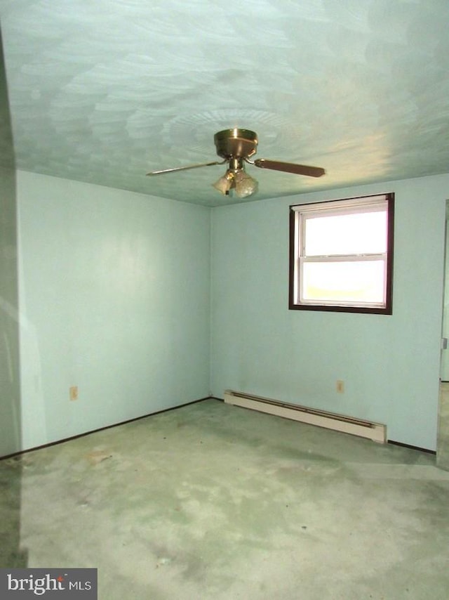 unfurnished room featuring a baseboard heating unit