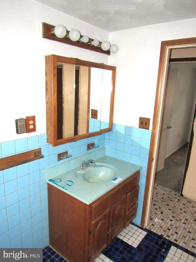 bathroom with tile patterned floors, vanity, and tile walls