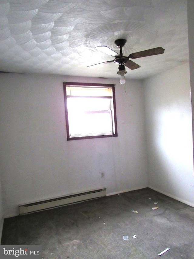 unfurnished room with ceiling fan, carpet, and baseboard heating