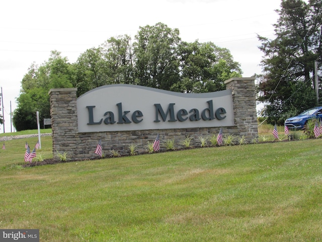 community / neighborhood sign with a lawn