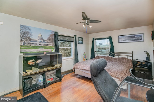 bedroom with wood-type flooring and ceiling fan