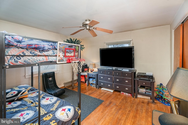 bedroom with multiple windows, hardwood / wood-style floors, and ceiling fan