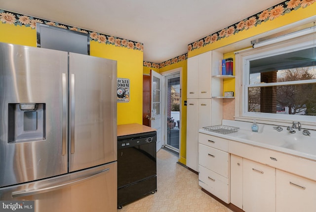 kitchen featuring white cabinetry, stainless steel fridge with ice dispenser, sink, and black dishwasher