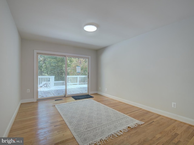 unfurnished room featuring light hardwood / wood-style floors