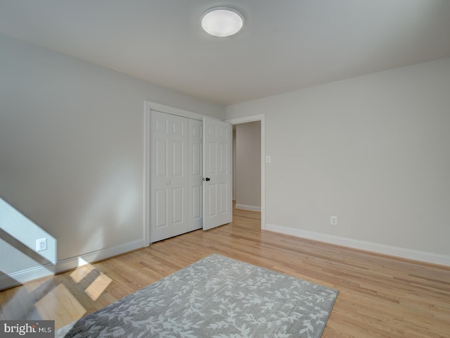 bedroom featuring light hardwood / wood-style floors and a closet