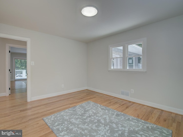 empty room with light hardwood / wood-style floors