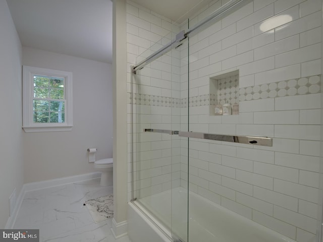 bathroom featuring bath / shower combo with glass door and toilet