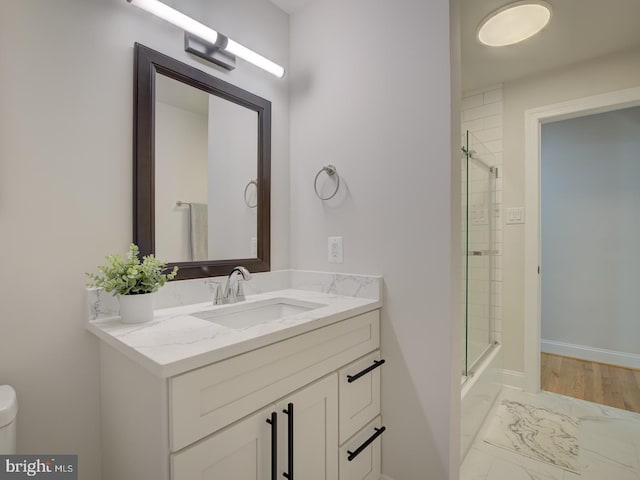 bathroom featuring vanity and enclosed tub / shower combo