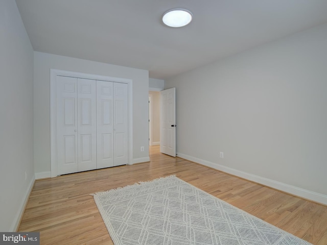 bedroom featuring light hardwood / wood-style floors and a closet