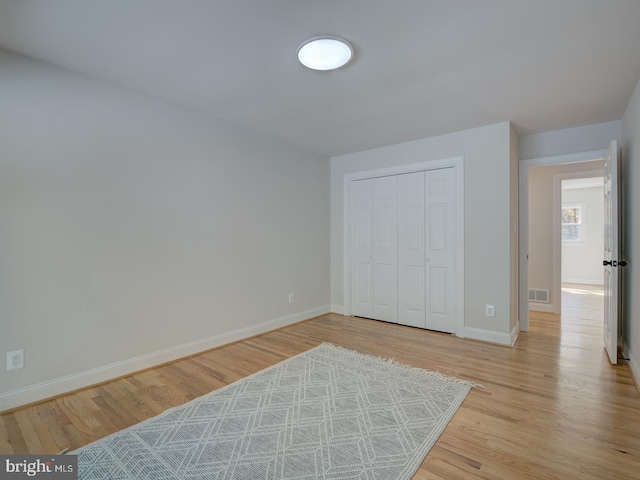 bedroom featuring a closet and light hardwood / wood-style flooring