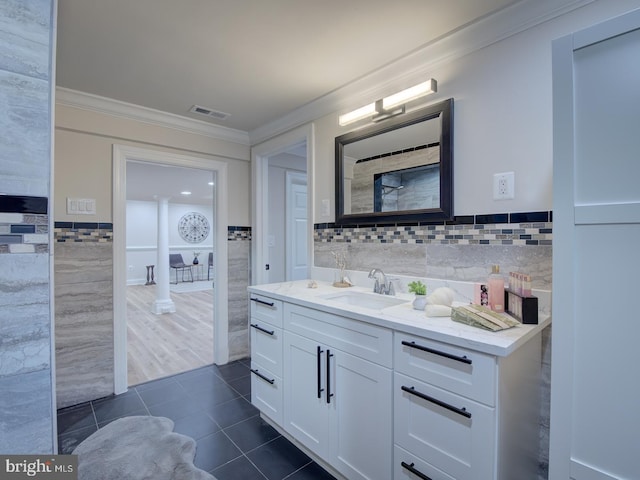 bathroom with ornamental molding, tile patterned floors, tile walls, and vanity