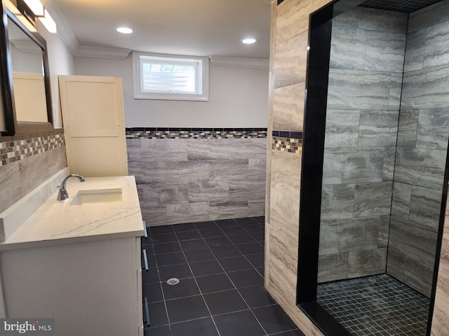 bathroom featuring vanity, tile patterned floors, ornamental molding, and tile walls