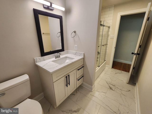 bathroom featuring vanity, a shower with shower door, and toilet