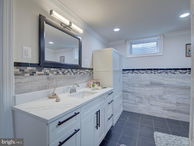 bathroom featuring tile walls, vanity, tile patterned flooring, and crown molding