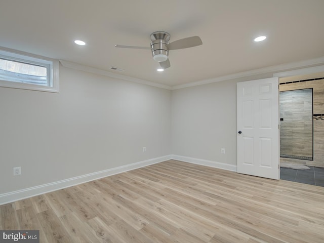 empty room featuring ceiling fan, ornamental molding, and light wood-type flooring