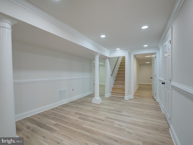 basement with crown molding and light hardwood / wood-style flooring