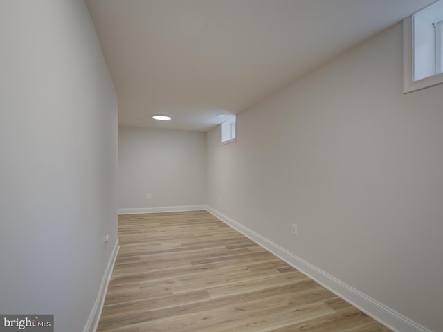 basement with light hardwood / wood-style flooring