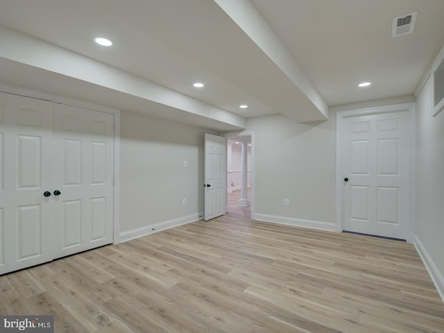 basement with light hardwood / wood-style floors