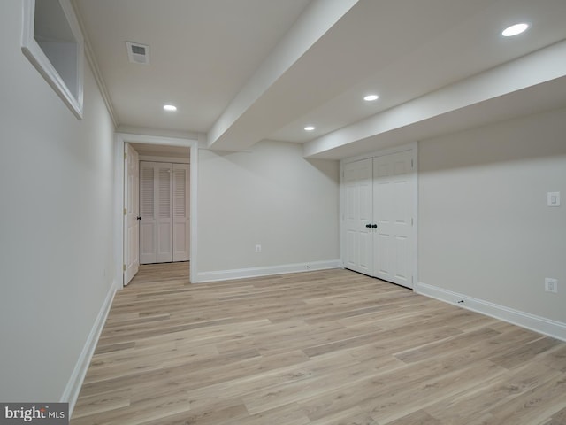 basement with light hardwood / wood-style floors