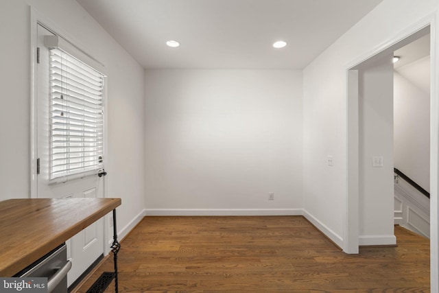 empty room with dark hardwood / wood-style flooring