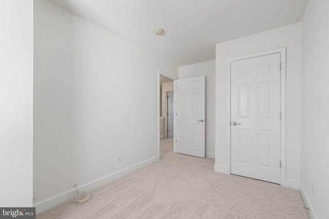 unfurnished bedroom featuring light colored carpet