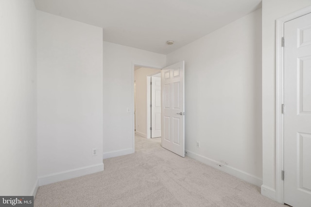 unfurnished bedroom with light colored carpet