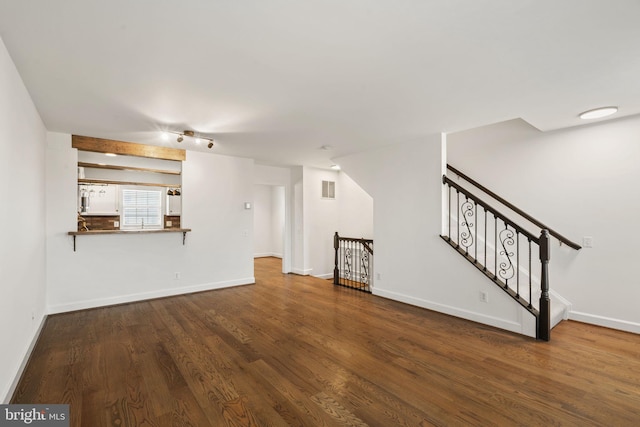 unfurnished living room featuring dark hardwood / wood-style flooring