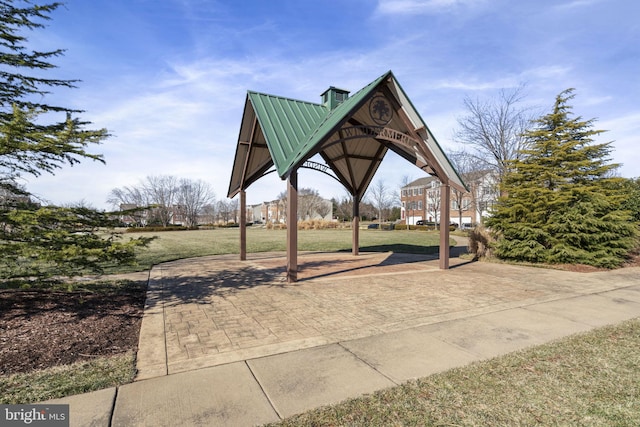 surrounding community with a gazebo and a yard