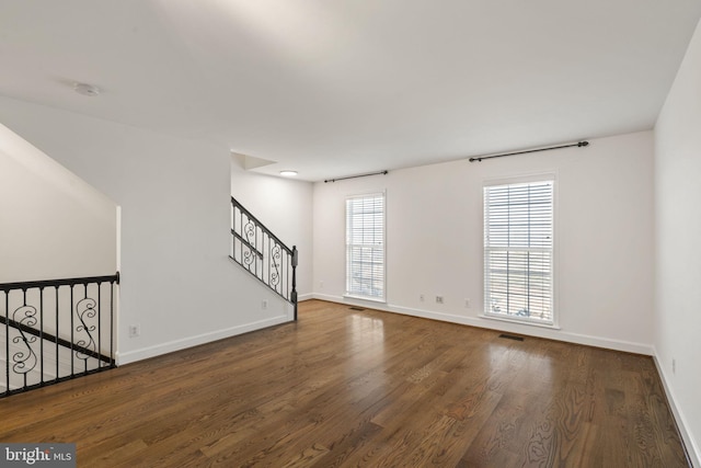 empty room featuring dark wood-type flooring