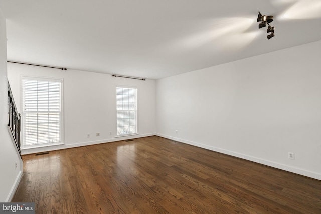 empty room featuring dark wood-type flooring