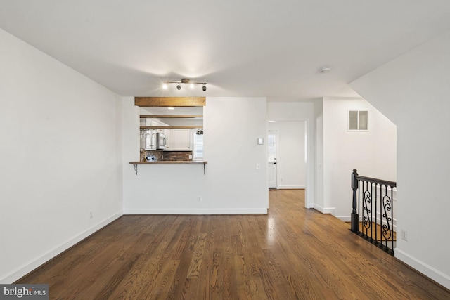 unfurnished living room with dark hardwood / wood-style floors