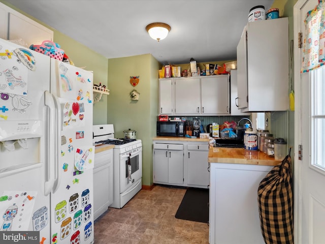 kitchen with sink, white appliances, wooden counters, and white cabinets